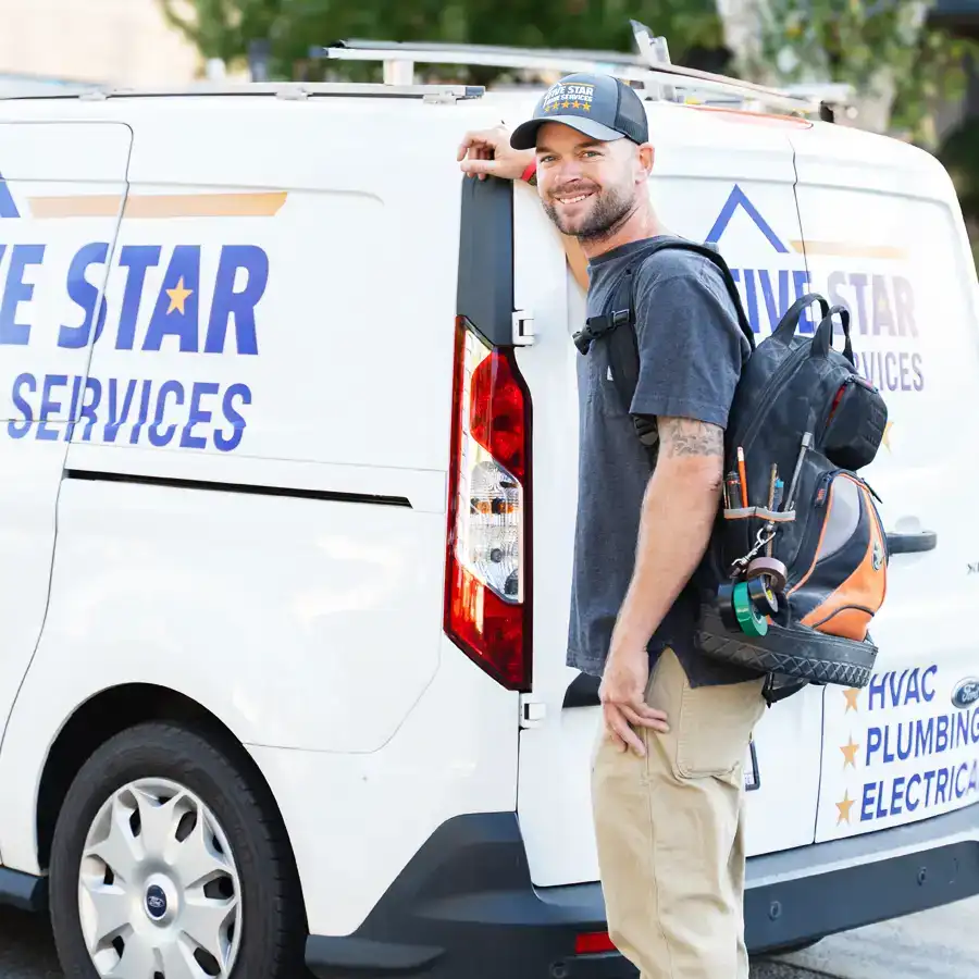 Plumber in front of a Five Star Home Services Van with a backpack full of tools