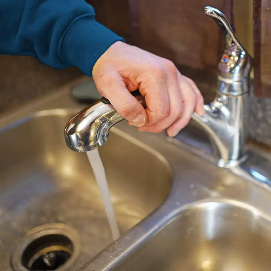 Close up of water running from a kitchen faucet