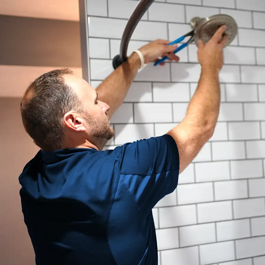 Plumber fixing a shower