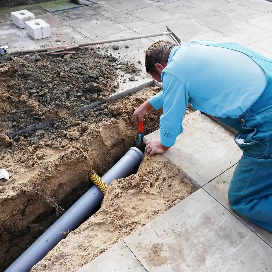 Plumbing installing a sewer line